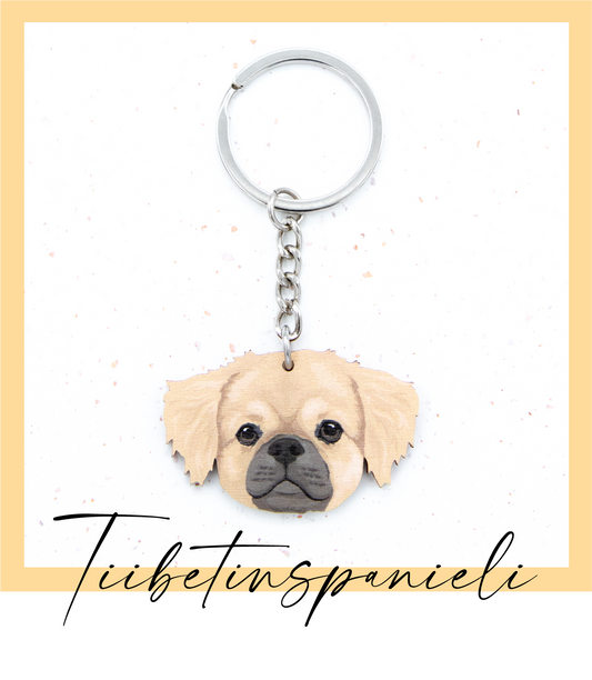 Suomalaisesta koivuvanerista ja teräksestä valmistettu tiibetinspanieli avaimenperä